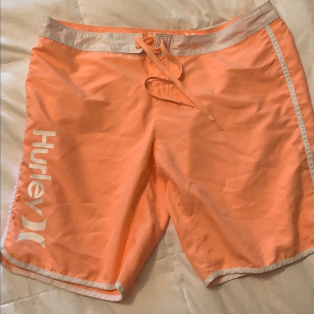 Hurley women’s long board shorts above the knee.